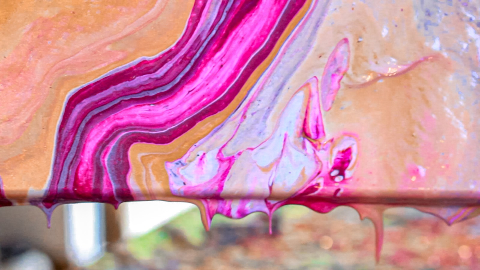 Close detail of pearlescent and metallic fluid acrylic cells forming on a finished painting